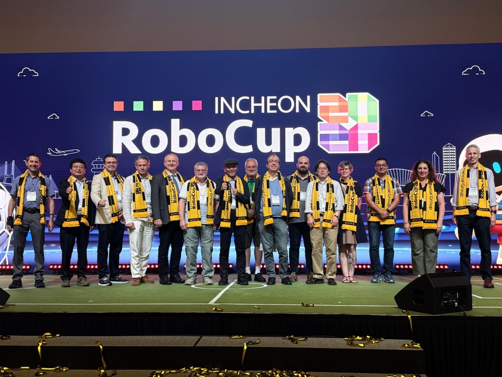 Roberto Bonilla with the RoboCup Trustees on stage, Incheon 2026